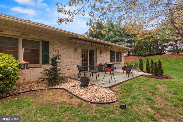 13113 Little Hayden Cir Unit 87, Hagerstown, MD 21742 - back of property with brick siding, a patio, and a lawn