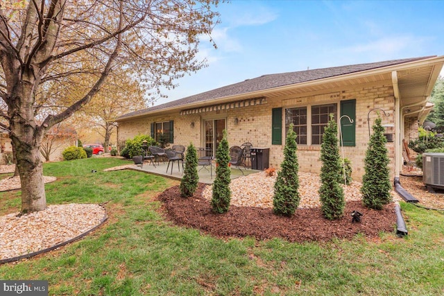 13113 Little Hayden Cir Unit 87, Hagerstown, MD 21742 - exterior space with central AC, a yard, a patio area, brick siding, and a shingled roof