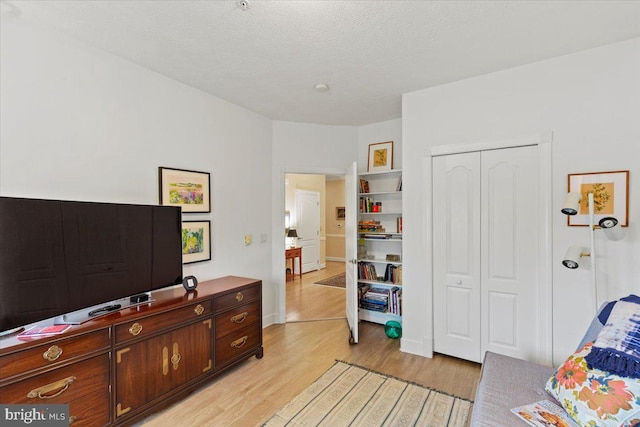 13113 Little Hayden Cir Unit 87, Hagerstown, MD 21742 - bedroom featuring a closet, light wood-style flooring, and a textured ceiling