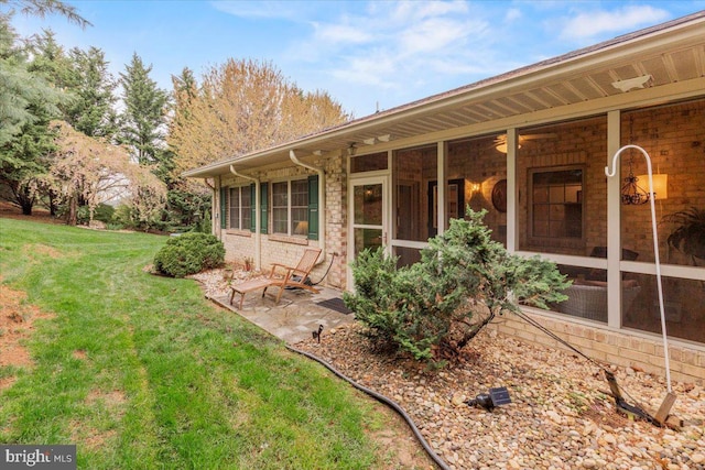 13113 Little Hayden Cir Unit 87, Hagerstown, MD 21742 - rear view of property featuring a patio area, brick siding, a sunroom, and a lawn