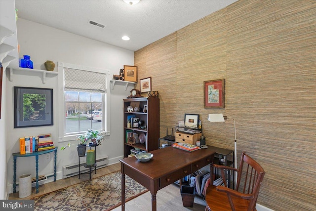 13113 Little Hayden Cir Unit 87, Hagerstown, MD 21742 - office space with baseboard heating, baseboards, visible vents, an accent wall, and wood finished floors