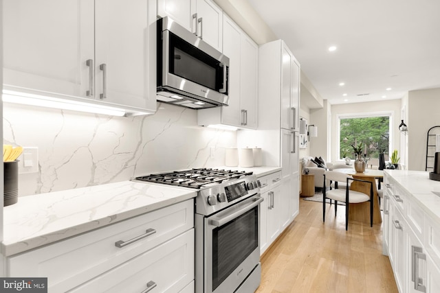 41 Q St NE Unit 2, Washington, DC 20002 - kitchen featuring appliances with stainless steel finishes, light wood-type flooring, white cabinets, and recessed lighting