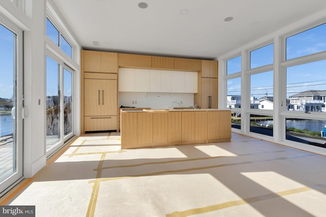 318 York Rd, South Bethany, DE 19930 - kitchen with light brown cabinets, refrigerator, a kitchen island, modern cabinets, and a water view