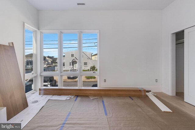 318 York Rd, South Bethany, DE 19930 - unfurnished bedroom with multiple windows, baseboards, and wood finished floors