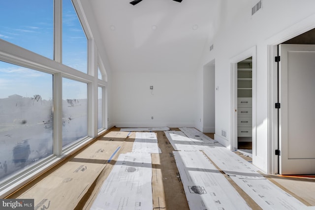 318 York Rd, South Bethany, DE 19930 - unfurnished living room with high vaulted ceiling, a ceiling fan, and baseboards