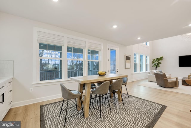 dining room with light wood-style flooring, recessed lighting, and baseboards