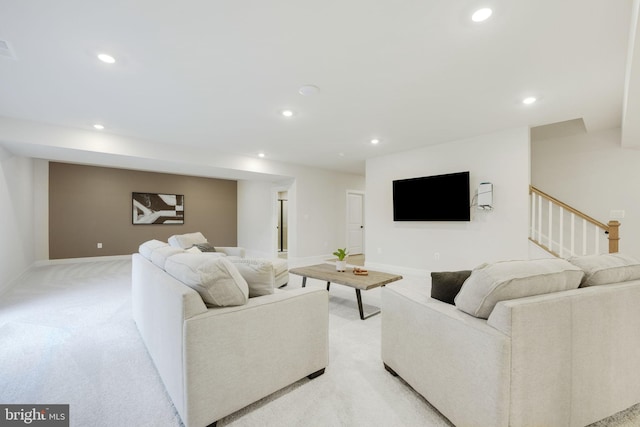 living room with light carpet, recessed lighting, baseboards, and stairs