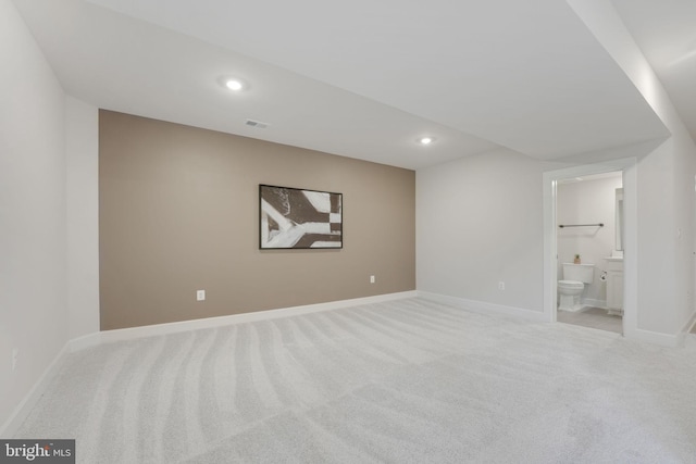 below grade area featuring visible vents, baseboards, carpet, and recessed lighting