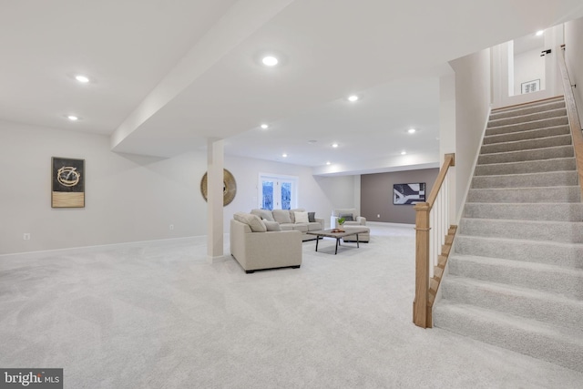 living room with light carpet, recessed lighting, baseboards, and stairs