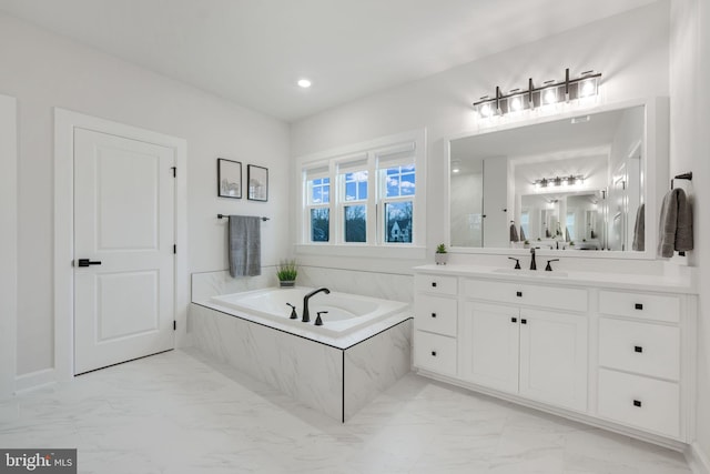 bathroom featuring recessed lighting, vanity, a bath, and marble finish floor