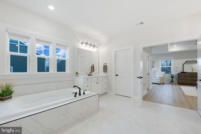 bathroom featuring a garden tub, vanity, visible vents, recessed lighting, and marble finish floor