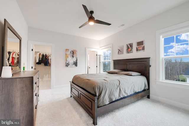 bedroom featuring a spacious closet, visible vents, baseboards, and a closet