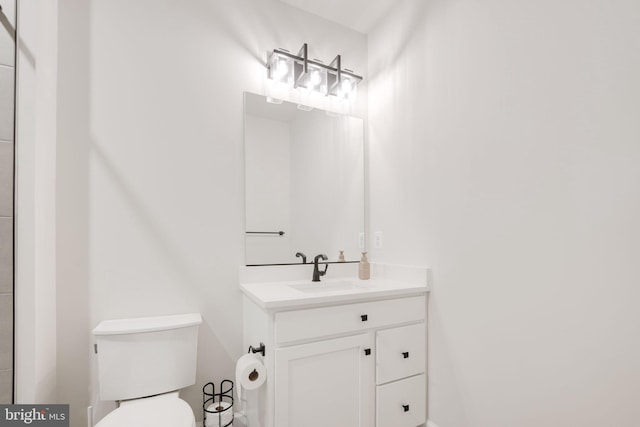 bathroom featuring toilet and vanity