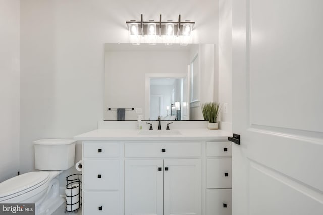 half bathroom with vanity and toilet