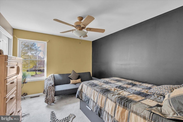 bedroom with visible vents, ceiling fan, and carpet flooring
