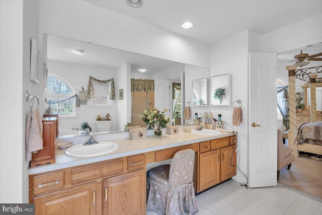 full bath featuring double vanity, ensuite bath, a sink, and ceiling fan