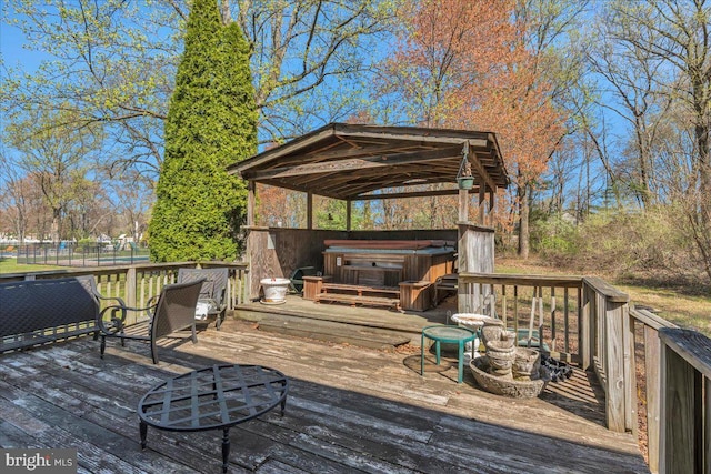deck with a gazebo and a hot tub