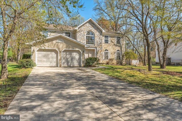 view of front of property featuring a garage, stucco siding, stone siding, a front lawn, and driveway