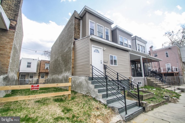 view of front of house with entry steps and fence