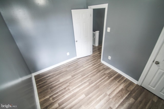 unfurnished bedroom featuring baseboards and wood finished floors