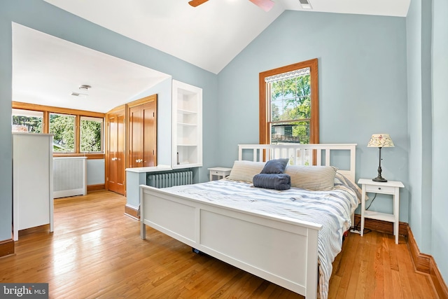 7812 Takoma Ave, Takoma Park, MD 20912 - bedroom with vaulted ceiling, multiple windows, light wood-style flooring, radiator heating unit, and baseboards