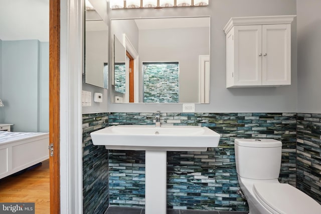 7812 Takoma Ave, Takoma Park, MD 20912 - bathroom featuring toilet, wainscoting, tile walls, and wood finished floors