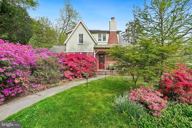 7812 Takoma Ave, Takoma Park, MD 20912 - english style home with a chimney, brick siding, stucco siding, and a front yard