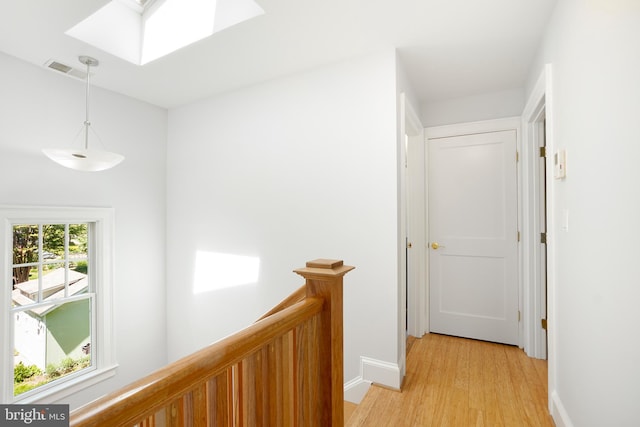 7812 Takoma Ave, Takoma Park, MD 20912 - hallway with an upstairs landing, light wood finished floors, a skylight, and baseboards