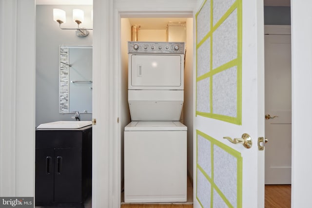 7812 Takoma Ave, Takoma Park, MD 20912 - laundry room featuring stacked washer and clothes dryer and wood finished floors