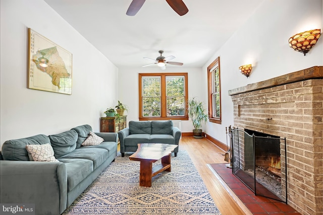 7812 Takoma Ave, Takoma Park, MD 20912 - living area with ceiling fan, a brick fireplace, light wood-style flooring, and baseboards