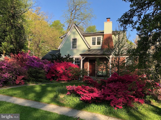 7812 Takoma Ave, Takoma Park, MD 20912 - view of front facade featuring a chimney, a standing seam roof, brick siding, stucco siding, and a front yard
