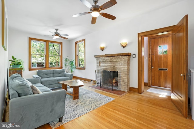 7812 Takoma Ave, Takoma Park, MD 20912 - living area featuring a ceiling fan, light wood-style flooring, a fireplace, and baseboards