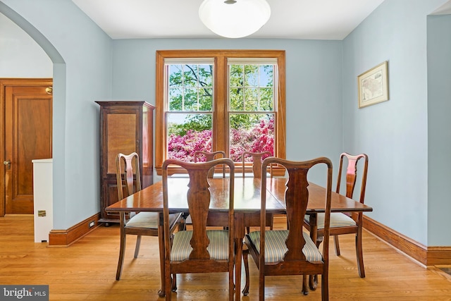 7812 Takoma Ave, Takoma Park, MD 20912 - dining area featuring arched walkways, baseboards, and light wood-style flooring