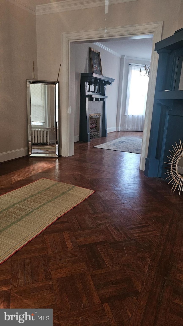 3563 Holmead Pl NW, Washington, DC 20010 - unfurnished living room featuring baseboards, ornamental molding, and a notable chandelier
