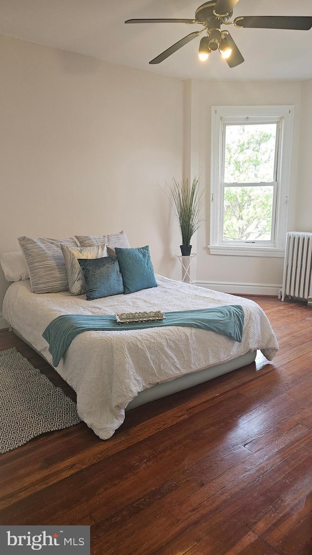 3563 Holmead Pl NW, Washington, DC 20010 - bedroom with radiator heating unit, baseboards, a ceiling fan, and wood finished floors
