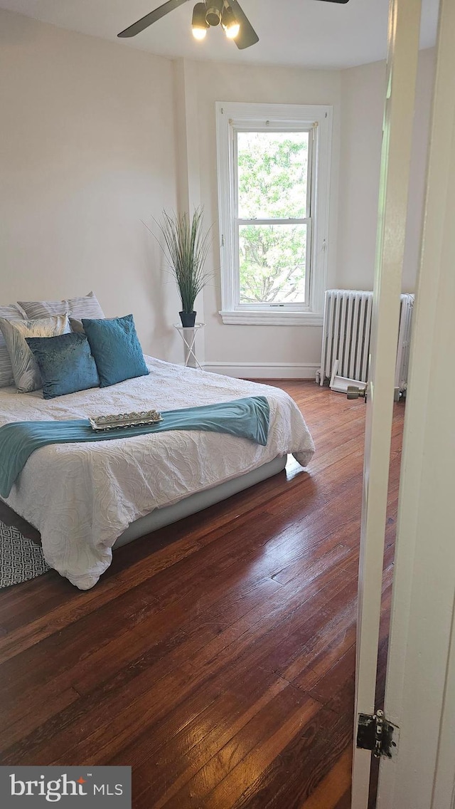 3563 Holmead Pl NW, Washington, DC 20010 - bedroom with baseboards, ceiling fan, wood finished floors, and radiator
