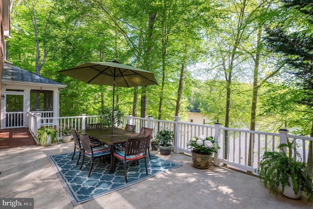 view of patio featuring a wooden deck and outdoor dining space