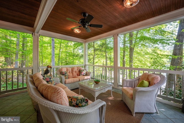 sunroom with an outdoor living space and a ceiling fan