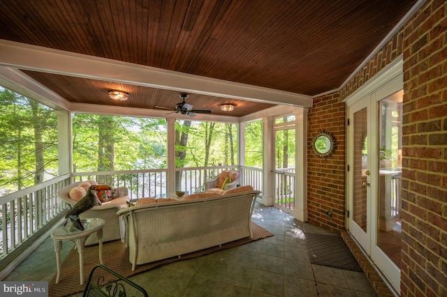 sunroom / solarium featuring french doors, ceiling fan, and outdoor lounge area