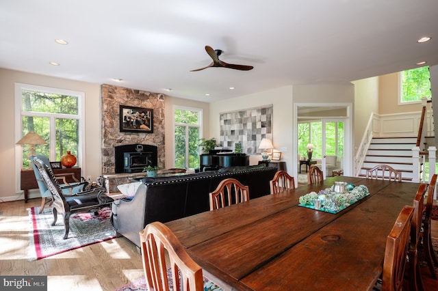 dining space featuring a ceiling fan, recessed lighting, light wood-style flooring, and a fireplace