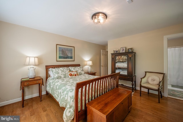 bedroom featuring baseboards and wood finished floors