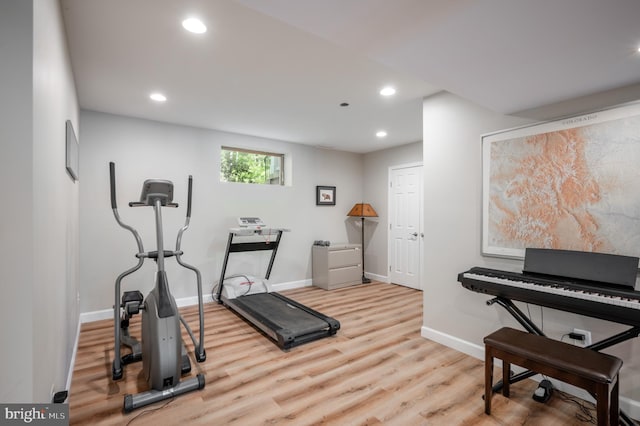 exercise room with baseboards, recessed lighting, and wood finished floors