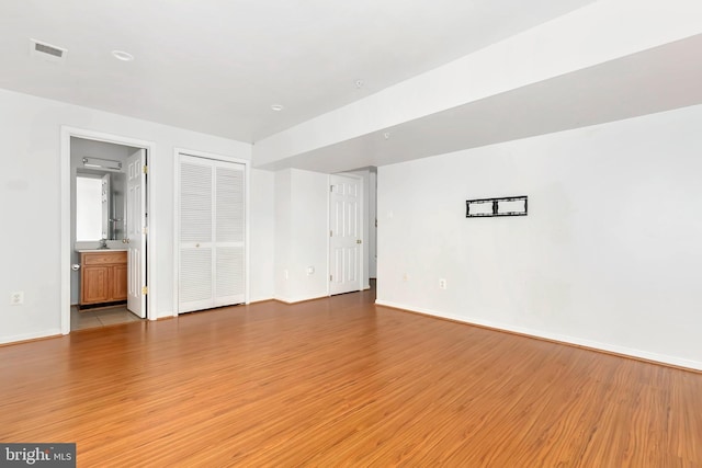 5830 Shady Oak Ln, Elkridge, MD 21075 - unfurnished bedroom with light wood finished floors, baseboards, a closet, and ensuite bathroom