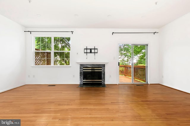 5830 Shady Oak Ln, Elkridge, MD 21075 - unfurnished living room featuring a premium fireplace, light wood-style flooring, and baseboards