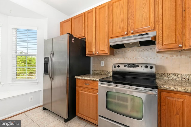 5830 Shady Oak Ln, Elkridge, MD 21075 - kitchen with appliances with stainless steel finishes, under cabinet range hood, backsplash, light tile patterned floors, and light stone countertops