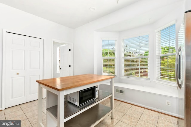 5830 Shady Oak Ln, Elkridge, MD 21075 - dining area with light tile patterned floors, healthy amount of natural light, and baseboards