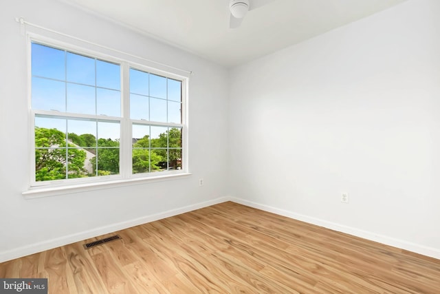 5830 Shady Oak Ln, Elkridge, MD 21075 - unfurnished room with baseboards, plenty of natural light, light wood-style floors, and a ceiling fan