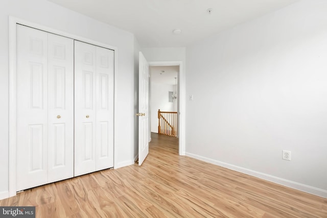 5830 Shady Oak Ln, Elkridge, MD 21075 - unfurnished bedroom with light wood finished floors, baseboards, and a closet