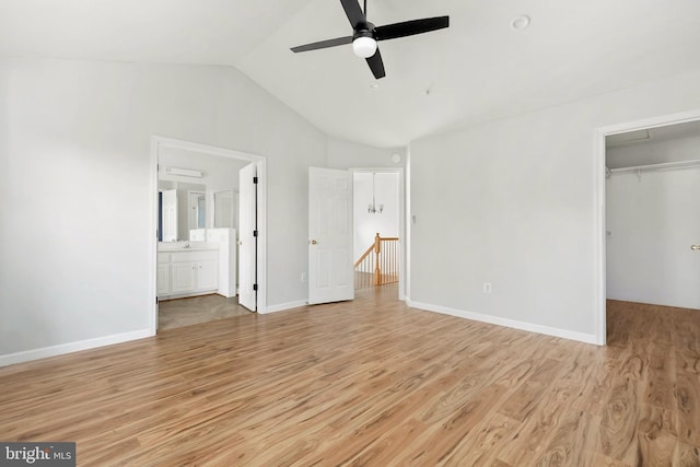 5830 Shady Oak Ln, Elkridge, MD 21075 - unfurnished bedroom with attic access, light wood-type flooring, vaulted ceiling, a spacious closet, and a closet