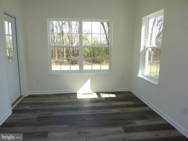interior space featuring wood finished floors and baseboards